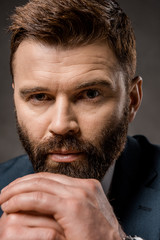 close up of handsome bearded man with praying hands