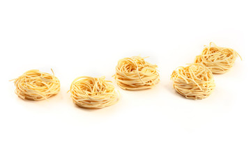 A photo of udon noodles in the shape of egg nests on a white background with copy space