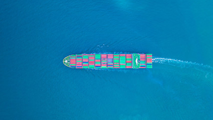 Aerial view cargo container ship carrying container for import and export, business logistic and transportation by ship in open sea.