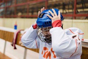 hockey player took hold of his head and was very upset that his team scored a goal