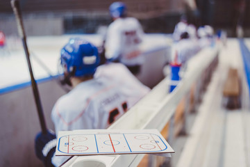 hockey players sit on the bench during the match