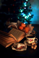 A cup of tea and an open book in the evening.