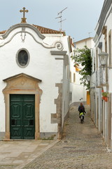 Nossa Senhora da Piedade Church, located along a typical cobbled narrow street inside the old town of Tavira, Algarve, Portugal