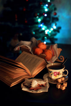 A cup of tea and an open book in the evening.