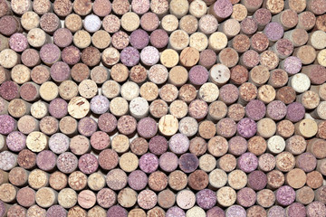 old wine corks from red wine among used wine corks from white wine and from sparkling wine as abstract brown cork background