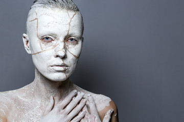 Art portrait of woman covered in clay