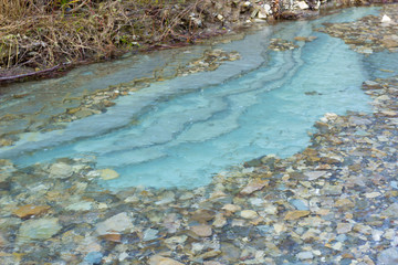 blue stones at the bottom of a mountain river