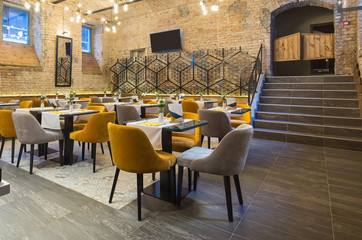 Interior of a modern hotel restaurant with brick wall
