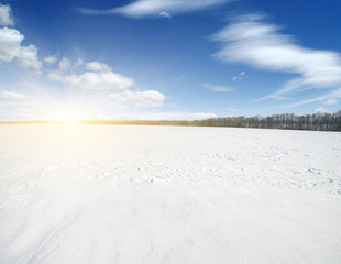 Snowcovered fields on  sky and sun.