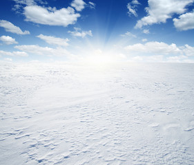 Snowcovered fields on  sky and sun.