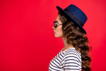 Close-up profile side view portrait of nice lovely well-groomed attractive gorgeous content wavy-haired lady wearing striped pullover sunhat isolated over bright vivid shine red background