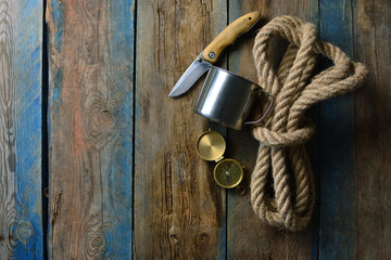 Hunting saver wallpaper. Brutal and sever background with a copy space. Rope, knife, compass and...