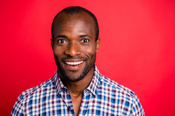 Close-up portrait of nice handsome attractive cheerful cheery optimistic guy wearing checked shirt isolated over bright vivid red background