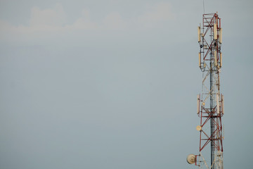 Metal antenna for radio and microwave transmission equipment on foggy blue sky
