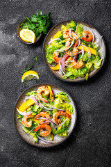 Fresh Shrimps, Mango Avocado lettuce salad, olive oil and lemon dressing. healthy food. Top view, gray background
