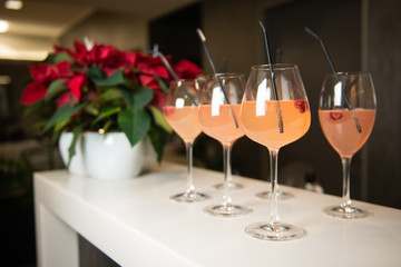 Beautiful women's welcome drinks with raspberries and black tubules in luxury beauty salon. Valentine's Day or Women's day party.