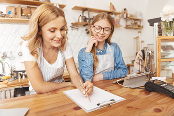 Joyful family taking notes while working in cafe