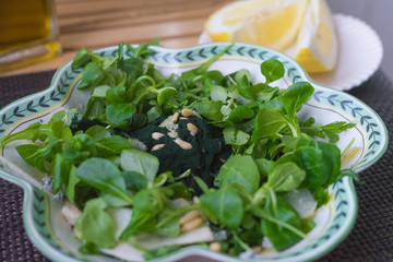 Cornsalad with spirulina in the bowl. Healthy meal concept.