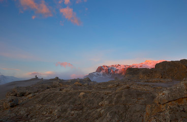 Two photographers and a dog meet the dawn in the mountains