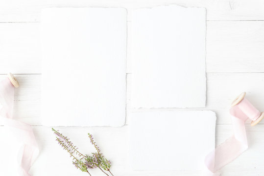 Wedding flat lay, birthday desktop mock-up. Invitation card mockup, template Blank greeting cards, rspv card, 5x7, square card, envelope. Silk ribbons, pink, blossom. White wooden table background