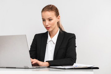 Pretty young business woman wearing suit isolated