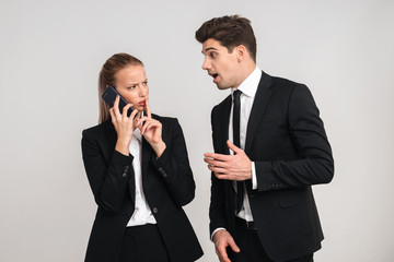 Portrait of a confident young business couple wearing suits