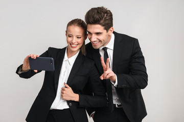 Portrait of a happy young business couple wearing suits