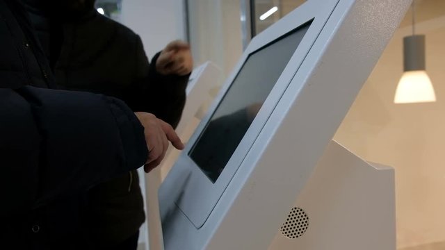 Man order gadgets from digital menu. People choose goods in the store.

