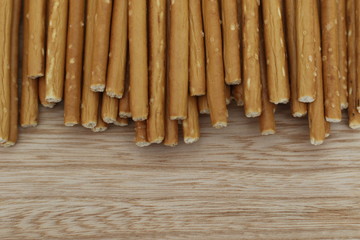 Salty stick crackers on wooden desk