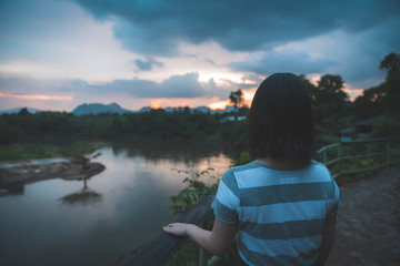 Fototapeta premium Happy young cute asian girl hipster backpack women travelling looking at beautiful sky mountains scenery views 