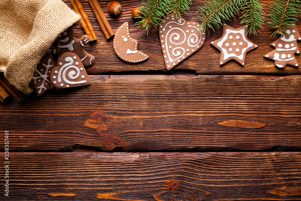 Poster Gingerbread Christmas cookies and spruce tree on wooden background