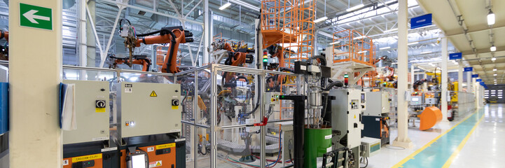 Automated Assembly process of cars by robots. Automotive production line. long format. Wide frame