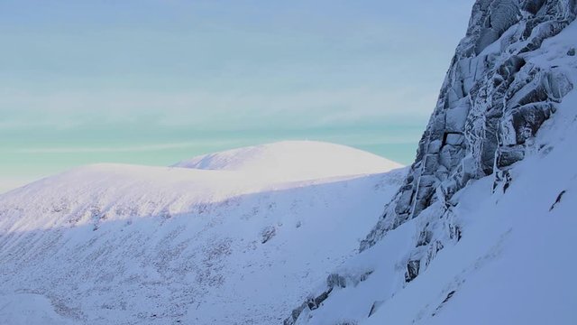 half way up the cliff face at the end of sneachda in the cairngorms national park, scotland looking towards carn gorm with snow and ice in winter