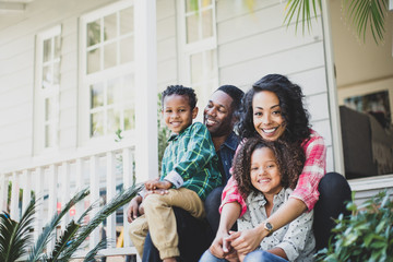 Smiling family sitting outdoors
