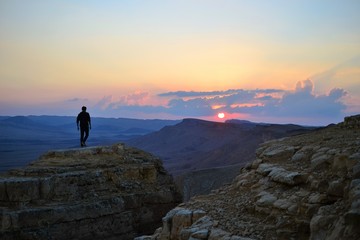Naklejka na ściany i meble Sunset at Mitzpe Ramon crater, camel rock at Makhtesh Ramon, Negev desert, South Israel