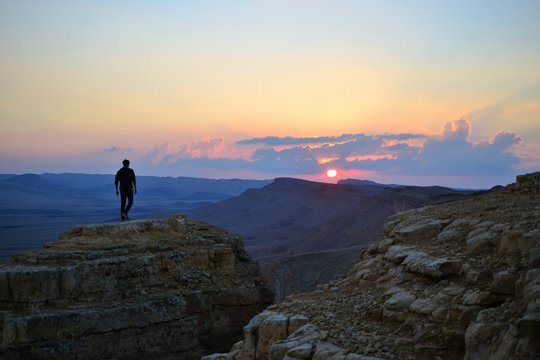 Sunset at Mitzpe Ramon crater, camel rock at Makhtesh Ramon, Negev desert, South Israel