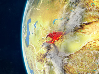Kyrgyzstan from space on model of planet Earth with country borders and very detailed planet surface and clouds.