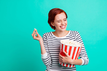 Pretty cheerful glad she her lady student millennial watching humorous reality show on local channel hold big box of pop corn isolated vibrant turquoise background copy space