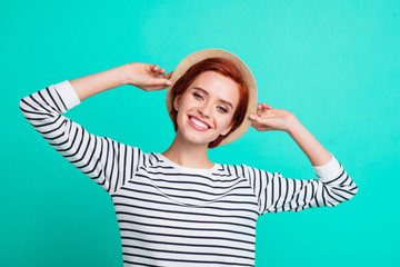 Fototapeta premium Close up photo portrait of excited cheerful lovely sweet cute attractive glad nice stunning glamorous luxurious she her lady student touching sun hat isolated turquoise background