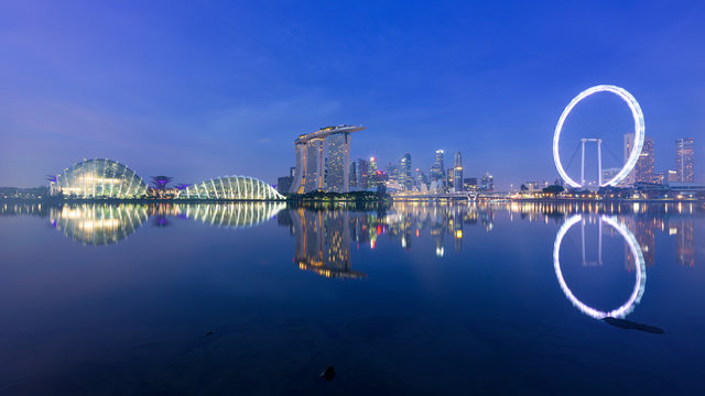 Singapore, 30 Oct 2018: a sunrise skyline view of the Marina Bay with the Garden domes, the Marina Bay Sands hotel and the Flyer Wheel in Singapore.