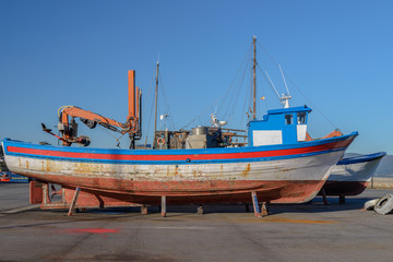 old wooden fishing boat on the shore to dry