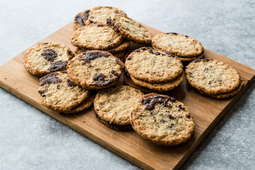Classic Swedish Oatmeal Cookies with Chocolate on Wooden Board.