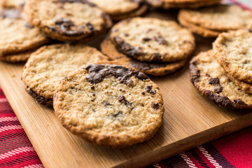 Classic Swedish Oatmeal Cookies with Chocolate on Wooden Board.