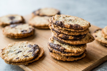Classic Swedish Oatmeal Cookies with Chocolate on Wooden Board.