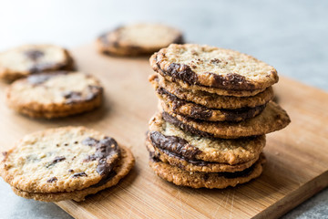 Classic Swedish Oatmeal Cookies with Chocolate on Wooden Board.