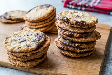 Classic Swedish Oatmeal Cookies with Chocolate on Wooden Board.