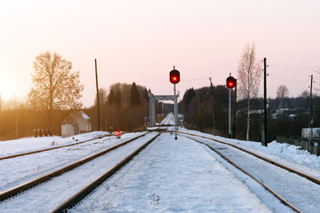 Small train station in winter at sunset time empty without train