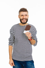 Positive handsome man enjoying his chocolate bar