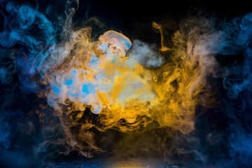 Obraz na płótnie Canvas yellow and blue smoke patterns at dark background