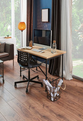 Wooden working table in the room, Computer and desktop yellow lamp and garden view, brown curtain and frame, home decor.